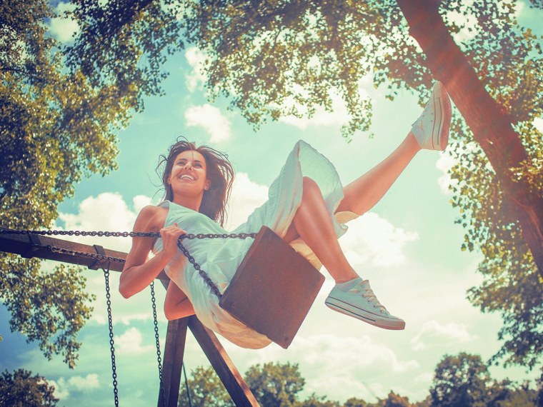 Счастливая девушка на качелях