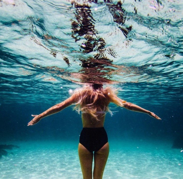 Девушка в воде со спины