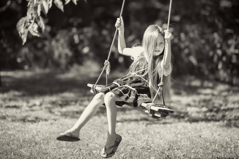 Девушка качается на качелях