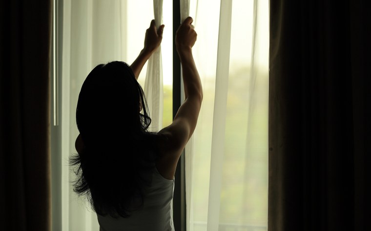 Девушка у окна со спины