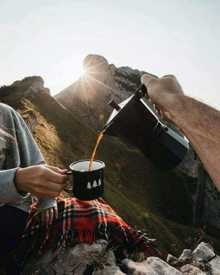 Чашка кофе в руке на море