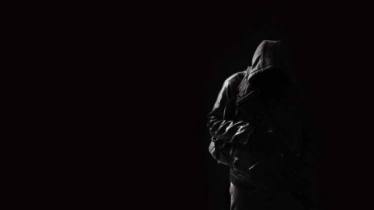 Человек в капюшоне в темноте